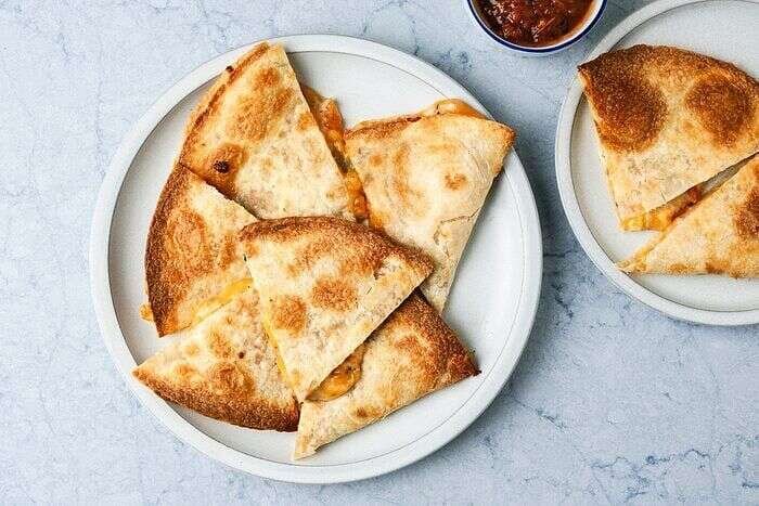 Crispy air-fryer quesadilla wedges served on a plate