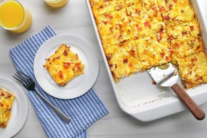 Amish breakfast casserole served in slices with orange juice
