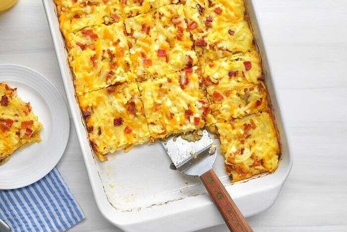 Amish breakfast casserole served with orange juice at brunch