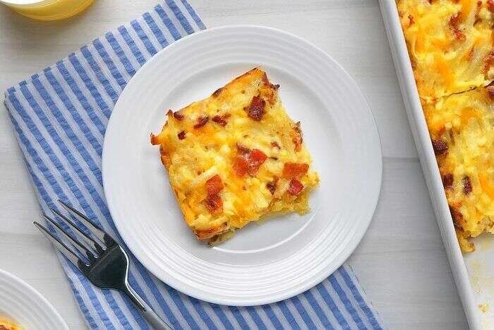 Freshly baked Amish breakfast casserole cut into serving portions