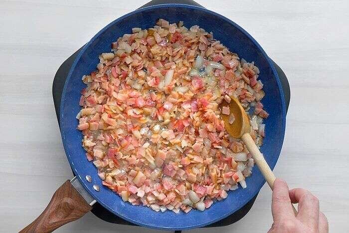 Bacon and sweet onion cooking for Amish breakfast casserole