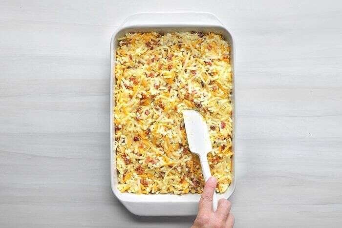Amish breakfast casserole mixture transferred to a greased baking dish
