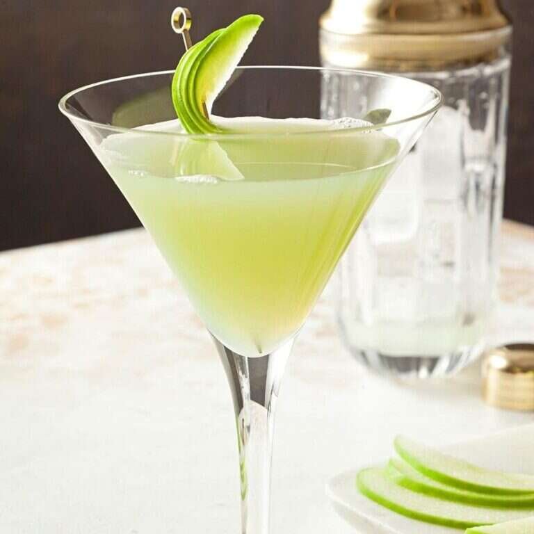 Easy Apple Martini Recipe with Sour Apple Flavor Apple martini with a bright green color and fresh apple garnish