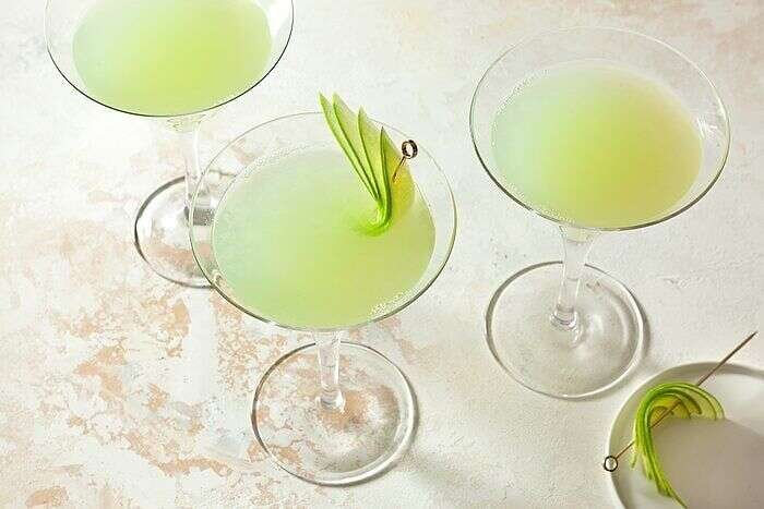 Apple martini served in chilled glasses with green apple garnish