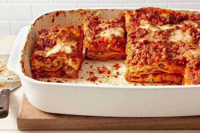Golden cheesy lasagna ready to slice and serve