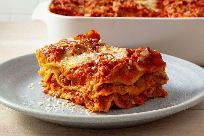Baked homemade lasagna served in a dish with melted cheese