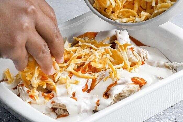 Chicken, Buffalo wing sauce, dressing, and cheese layered for the dip