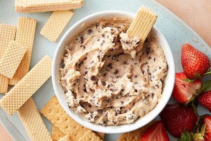Chocolate chip dip in a bowl served with a cracker
