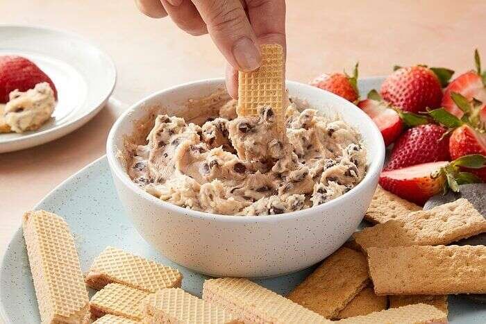 Chocolate chip dip being served with a cracker