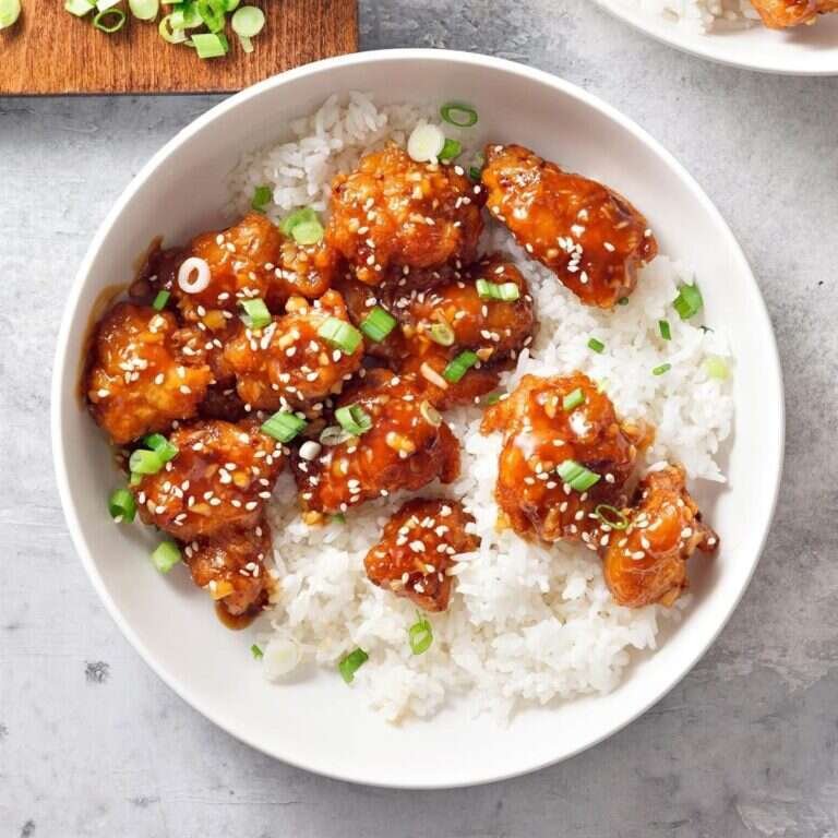 Copycat Panda Express orange chicken with crispy coating and glossy orange sauce