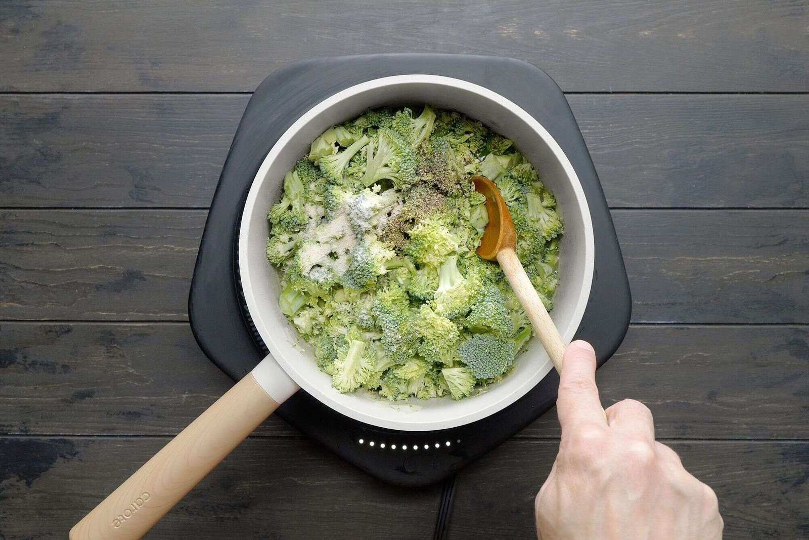 Broccoli cooking with chicken broth and seasonings for soup