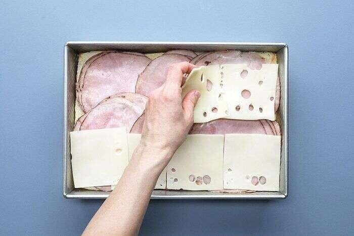 Layering ham and Swiss cheese for Cuban sliders