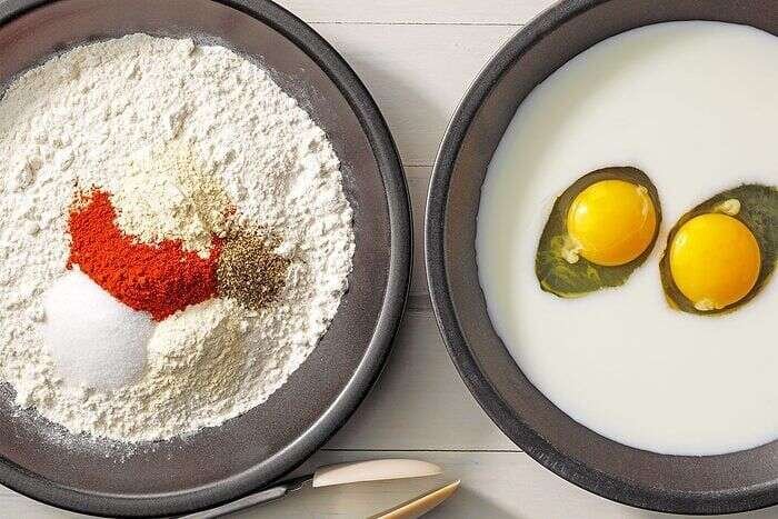 Seasoned flour and egg mixture prepared for deep-fried chicken legs