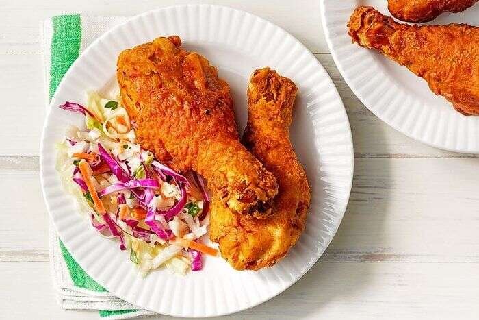 Deep-fried chicken legs served with salad on plates