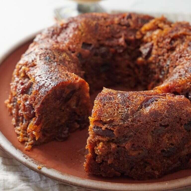 Plum pudding with warm spices, dried fruit, and creamy hard sauce