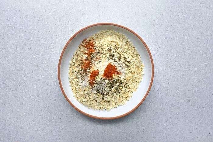 Crushed saltines and seasonings prepared for crispy chicken strips
