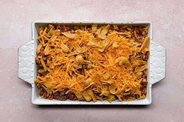 Reserved Fritos sprinkled over assembled Frito pie