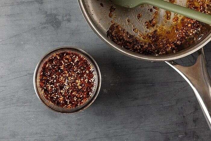 Freshly made homemade chili crisp cooling in a heatproof container