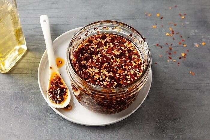 Jar of homemade chili crisp with crispy garlic and chili flakes