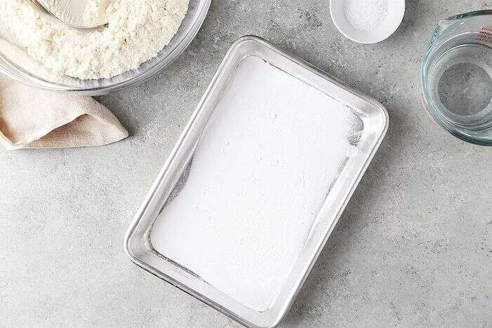 Baking soda spread on a baking sheet for homemade ramen noodles