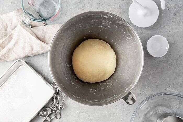 Ramen dough forming in a stainless steel mixing bowl