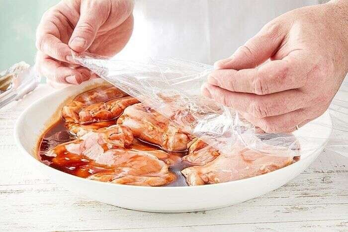 Marinated Huli Huli Chicken thighs ready to drain before grilling