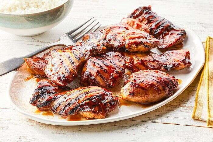 Grilled Huli Huli Chicken served with rice on a platter