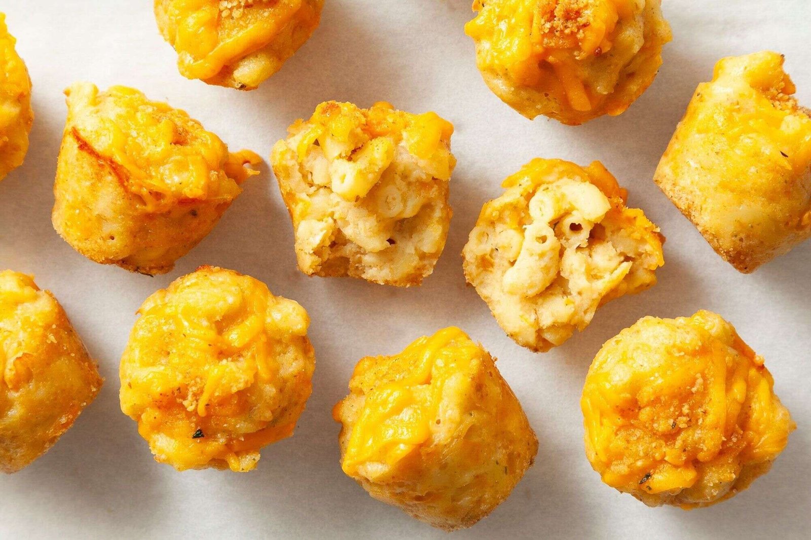 Golden baked mini mac and cheese bites ready to serve