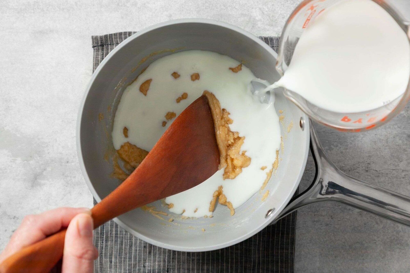 Milk whisked into creamy sauce for mac and cheese bites