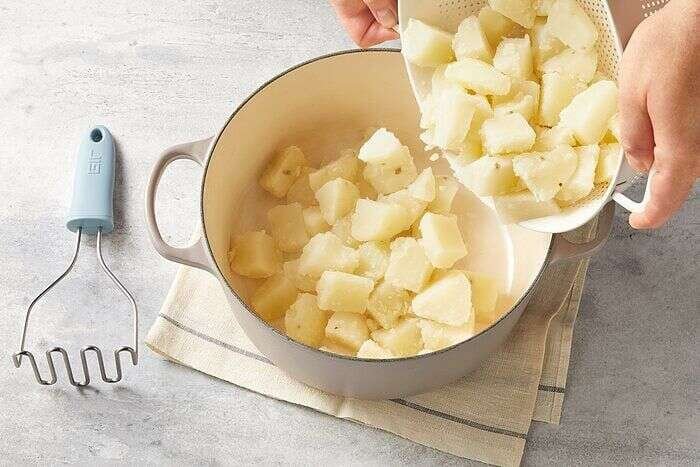 Cooked potatoes draining before making creamy mashed potatoes