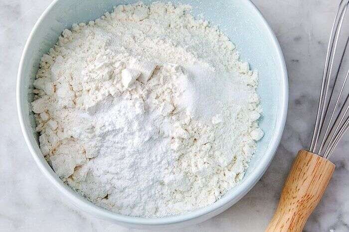 Flour, baking powder, and salt whisked for orange olive oil cake