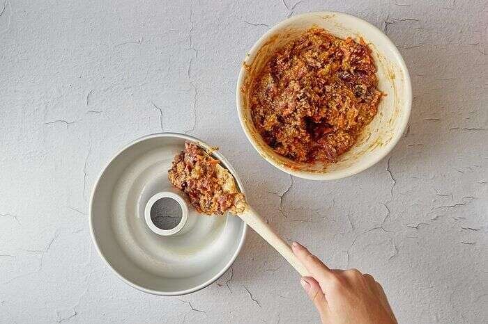 Transferring plum pudding batter to the prepared mold