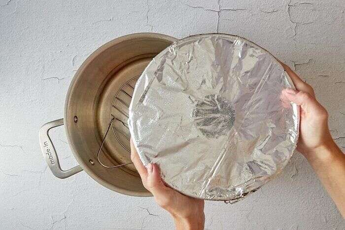 Steaming the plum pudding in a stockpot