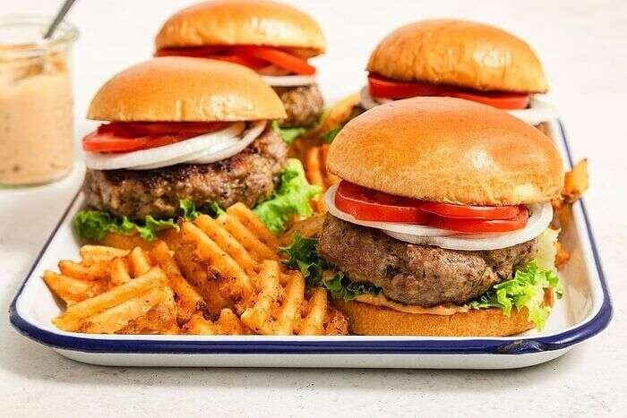 Grilled pork burgers served in a tray