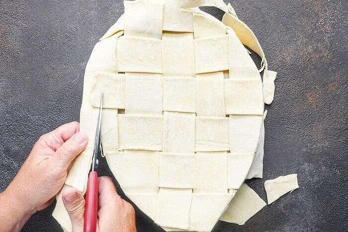 Puff pastry lattice placed over chicken potpie filling