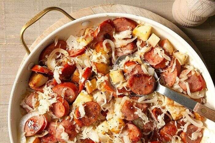 Sausage and sauerkraut cooking together in a skillet