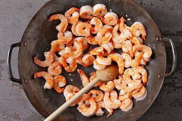 Shrimp searing in a wok for shrimp mei fun