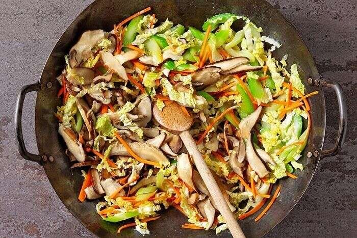 Shiitake mushrooms and napa cabbage added to shrimp mei fun vegetables