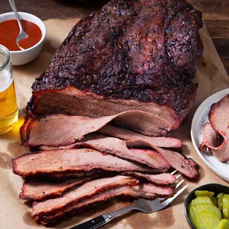 Smoked brisket with a dark peppery bark and tender sliced beef
