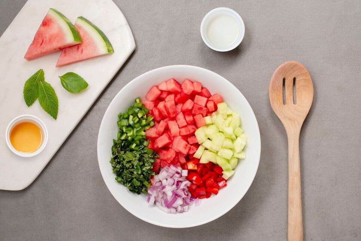 Watermelon cucumber onion pepper and herbs prepared for salsa