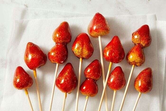 Tanghulu fruit skewers arranged on a kitchen countertop