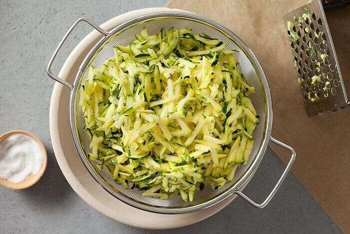 Shredded zucchini draining before making zucchini pizza casserole