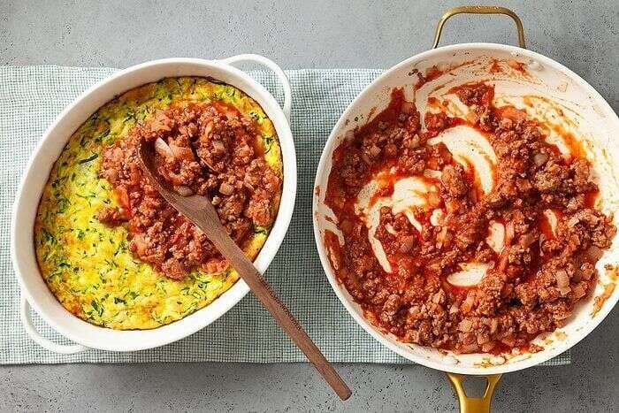Beef and tomato sauce layered over zucchini casserole base