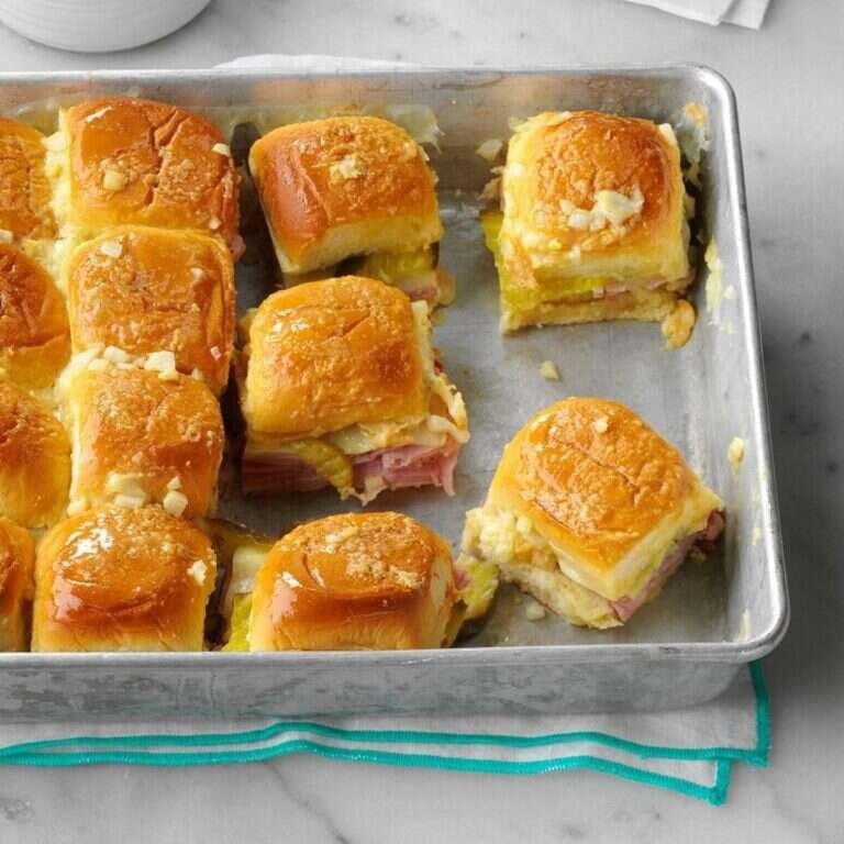 Easy Cuban Sliders Recipe for Parties and Weeknight Dinners Cuban sliders with ham, Swiss cheese, dill pickles, and buttery Dijon topping